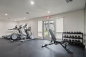 Thumbnail 30 of 48 - a gym with a lot of weights and mirrors at Monterra Ridge Apartments, Canyon Country, CA