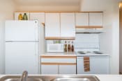 Thumbnail 13 of 18 - Kitchen with white interior at Oates Estates Apartments, Dothan, AL, 36303