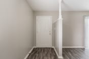 Thumbnail 12 of 22 - a bedroom with a white door and hardwood floors