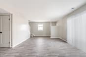 Thumbnail 15 of 22 - an empty room with a hardwood floor and white walls