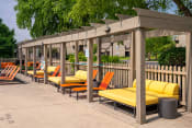 Thumbnail 34 of 35 - a row of orange and yellow lounge chairs under a wooden pergola