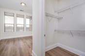 Thumbnail 22 of 40 - a bedroom with hardwood floors and white walls