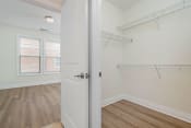 Thumbnail 9 of 40 - a bedroom with white walls and hardwood floors
