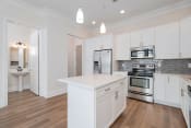Thumbnail 1 of 40 - a kitchen with white cabinets and stainless steel appliances