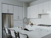 Thumbnail 9 of 43 - a kitchen with white cabinets and a white counter top