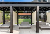 Thumbnail 34 of 82 - a pergola with two chaise lounges on a patio