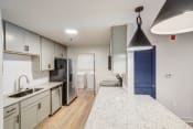 Thumbnail 1 of 14 - a renovated kitchen with white cabinets and a white counter top