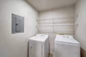 Thumbnail 10 of 14 - a laundry room with two washes and a dryer in it
