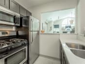 Thumbnail 4 of 34 - a kitchen with stainless steel appliances and a sink