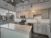Thumbnail 16 of 41 - Kitchen With Custom Cabinetry at The Tower Apartments, Tuscaloosa, AL