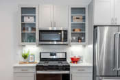 Thumbnail 3 of 47 - a kitchen with white cabinets and stainless steel appliances