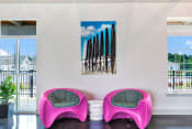 Thumbnail 40 of 47 - a room with two pink chairs and two surfboards on the wall