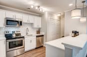 Thumbnail 17 of 22 - White cabinets and stainless steel appliances in select units at Triangle Park Apartments, North Carolina