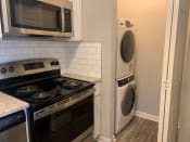 Thumbnail 9 of 22 - Stackable wash dryer next to kitchen at Triangle Park Apartments, North Carolina, 27713