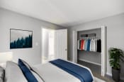 Thumbnail 2 of 22 - a bedroom with a bed and a closet with clothes
