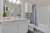 Thumbnail 19 of 60 - Bathroom with Soaking Tub, White Marble Countertop, and Custom White Cabinetry with Soft-Close Doors and Drawers