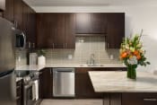 Thumbnail 2 of 25 - Kitchen with Stainless Steel Appliances & Espresso Oak Cabinetry