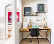Thumbnail 4 of 39 - a home office with a wooden desk and a black chair