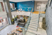 Thumbnail 9 of 39 - a view of the lobby of a building with stairs and a blue wall