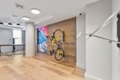 Thumbnail 16 of 39 - a bike is hanging on a wall in a room with wood floors and a wall