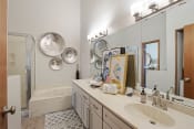 Thumbnail 13 of 21 - Townhomes In Woodbury - Large Bathroom With Hard-Wood Flooring, Dual Sinks, Large Mirrors, And Separate Tub And Shower.