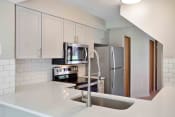 Thumbnail 2 of 21 - Updated kitchen with gray cabinets and stainless steel appliances