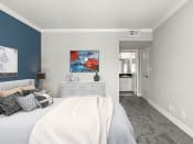 Thumbnail 5 of 27 - Carpeted bedroom with blue accent wall.