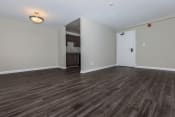 Thumbnail 2 of 10 - an empty living room with a kitchen in the background at Highland Ridge, Capitol Heights