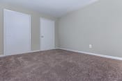 Thumbnail 5 of 10 - a bedroom with a carpeted floor and two doors at Highland Ridge, Maryland, 20743