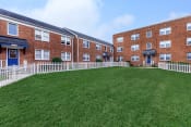 Thumbnail 9 of 10 - a large green lawn in front of a brick building at Highland Ridge, Capitol Heights, 20743