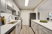 Thumbnail 3 of 25 - a kitchen with white cabinets and stainless steel appliances