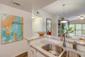 Thumbnail 6 of 44 - an open kitchen with a stainless steel sink and counter top