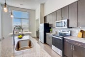 Thumbnail 4 of 38 - an open kitchen with stainless steel appliances and granite counter tops