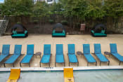 Thumbnail 42 of 50 - a row of blue and green chairs on the side of a pool