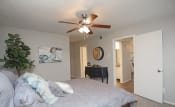 Thumbnail 9 of 12 - a bedroom with a large bed and a ceiling fan  at 1505 Exchange Apartments, Texas