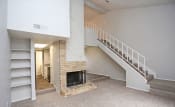 Thumbnail 8 of 12 - a living room with a fireplace and a staircase  at 1505 Exchange Apartments, Texas, 76112