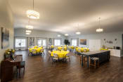 Thumbnail 9 of 31 - a large room with tables and chairs with yellow table cloths