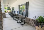 Thumbnail 3 of 31 - front porch of clubhouse with rocking chairs