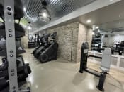 Thumbnail 22 of 63 - a gym with weights and other exercise equipment on a brick wall