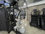 Thumbnail 25 of 63 - a gym with cardio equipment and a treadmill