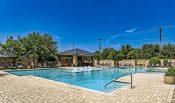 Thumbnail 86 of 94 - a swimming pool with a gazebo and chairs around it at Discovery at Craig Ranch, McKinney, Texas