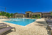 Thumbnail 84 of 94 - a swimming pool with chairs and a building in the background at Discovery at Craig Ranch, McKinney, TX, 75070