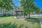 Thumbnail 83 of 94 - a park with trees and a picnic area in front of a building at Discovery at Craig Ranch, Texas, 75070