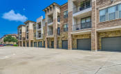 Thumbnail 75 of 94 - an empty parking lot in front of an apartment building at Discovery at Craig Ranch, McKinney