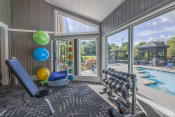 Thumbnail 18 of 27 - a home gym with a view of a swimming pool and glass doors  at Butternut Ridge, Ohio, 44070