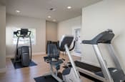 Thumbnail 19 of 39 - a home gym with treadmills and exercise bikes