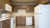 Thumbnail 26 of 39 - a kitchen with white appliances and wooden cabinets