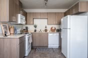 Thumbnail 1 of 39 - a kitchen with white appliances and wooden cabinets