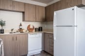 Thumbnail 3 of 39 - a kitchen with white appliances and wooden cabinets