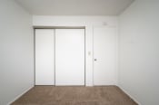 Thumbnail 17 of 22 - an empty room with white walls and white closet doors